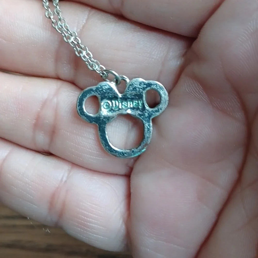 Disney silver toned necklace with Minnie Mouse pendant with green accent glitter